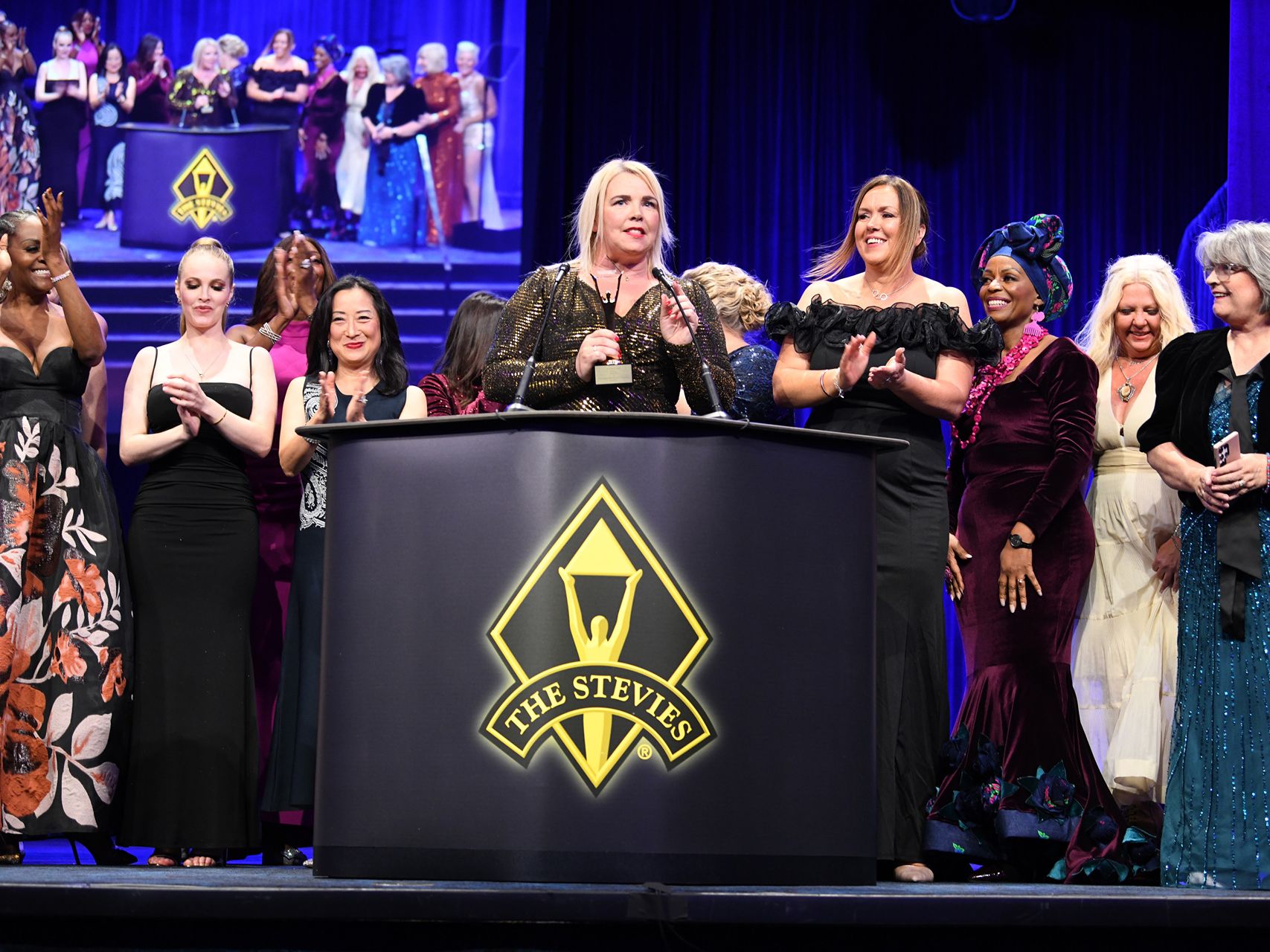 Stevie Award winners celebrating on stage at the awards ceremony