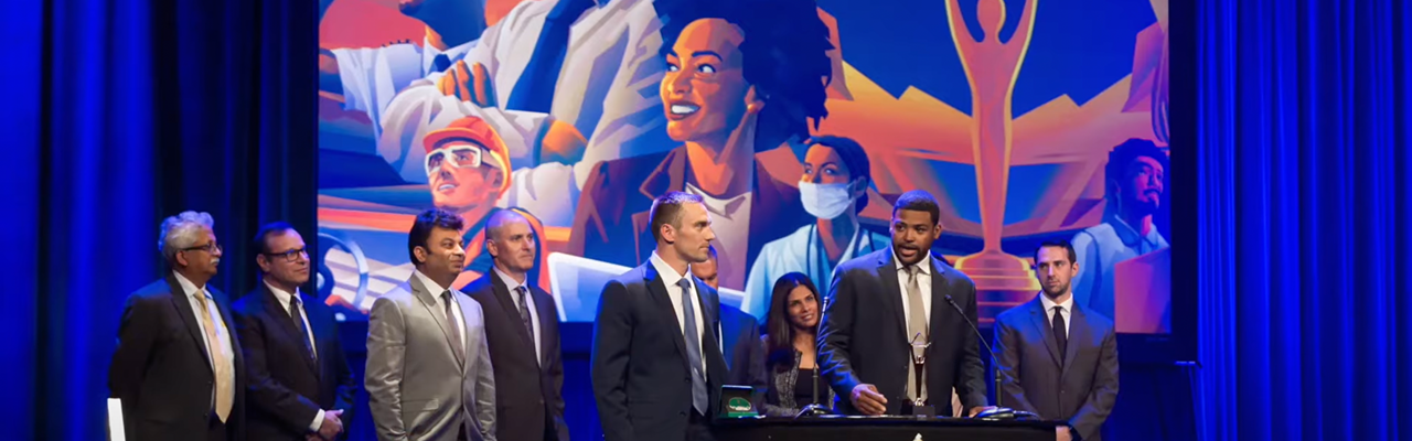 Stevie Award winners celebrating with their trophy